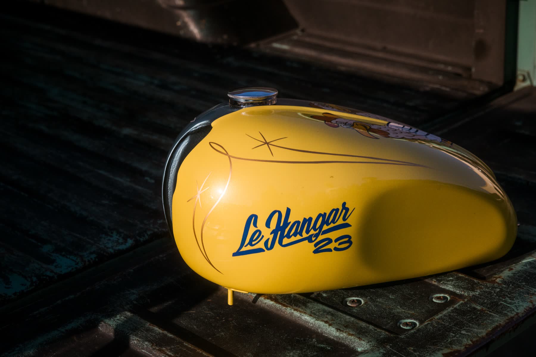Glossy yellow tank detail with carburetor visible