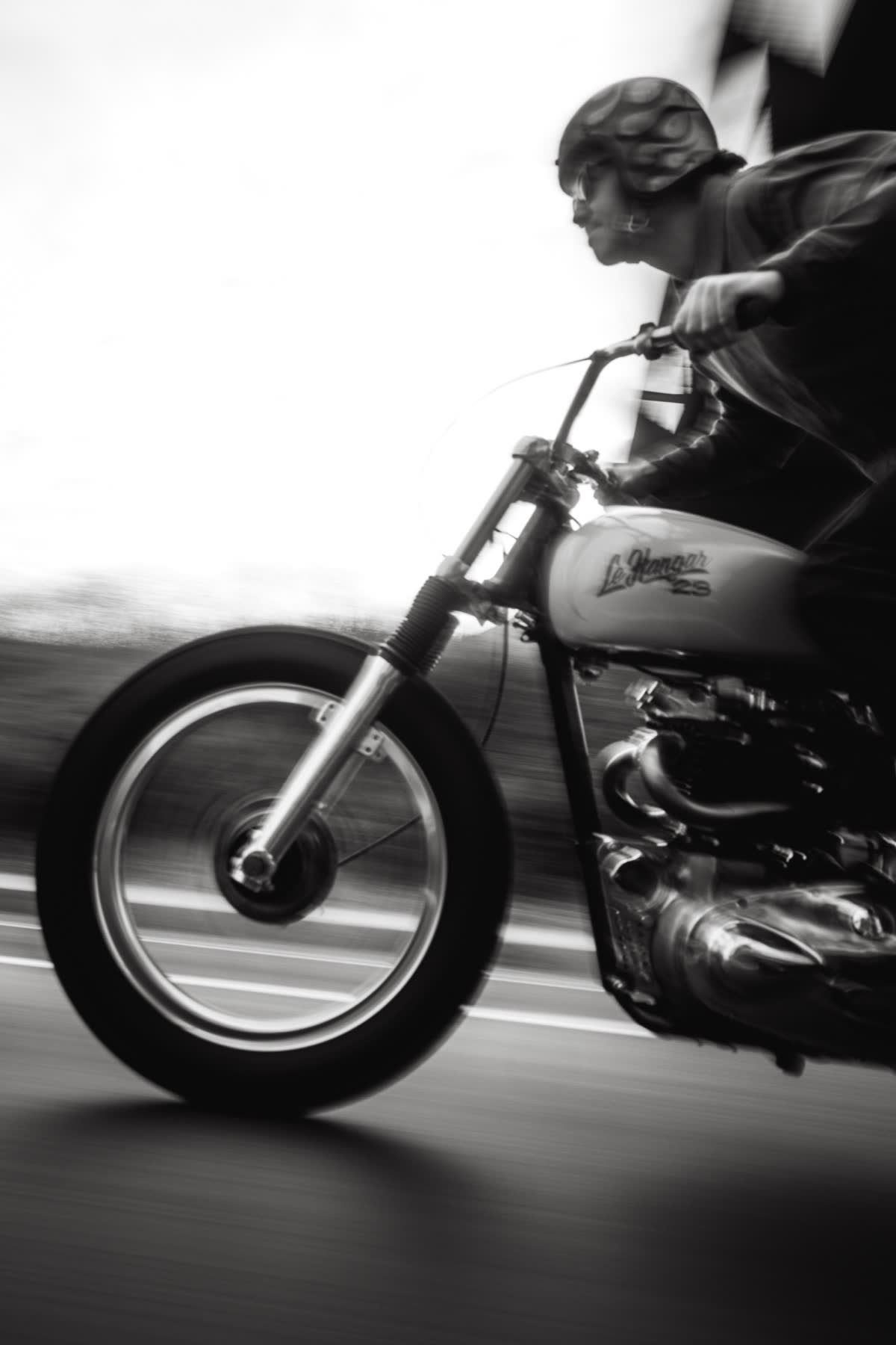 A vintage Triumph in motion in the desert, black and white
